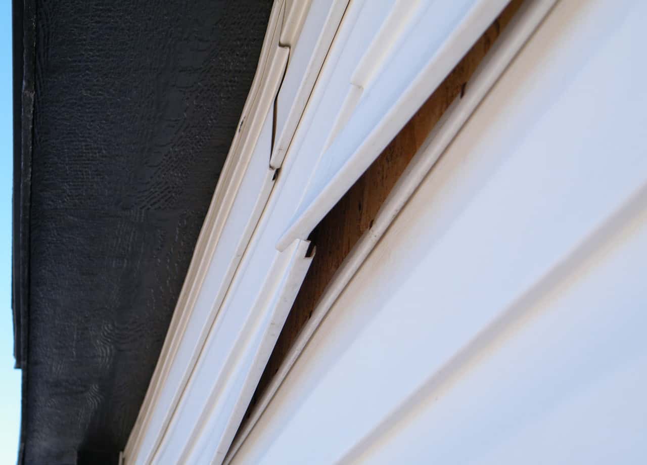 Image of siding on a home that has been damaged and is coming off. Our siding contractors provide siding repairs in Milford OH & Cincinnati OH.